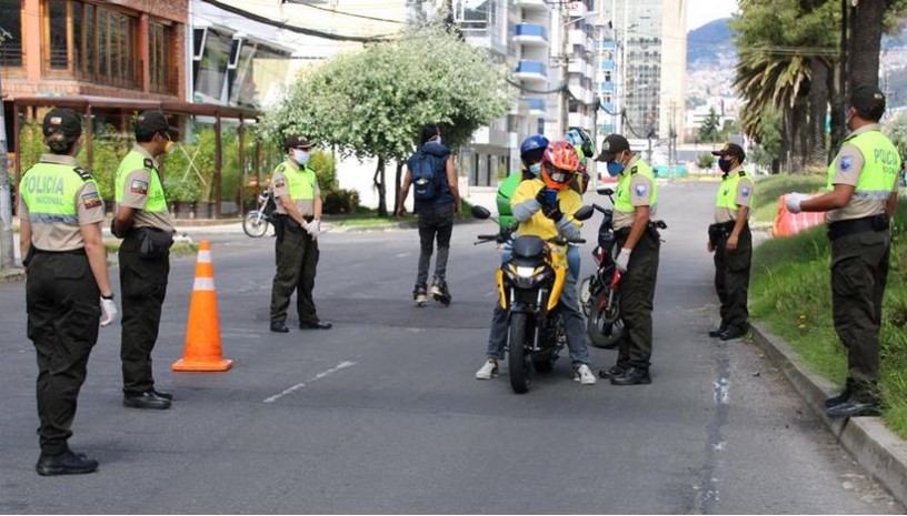   Agentes de la Policía Nacional revisan los documentos de conductores, en un puesto control en Quito. EFE 